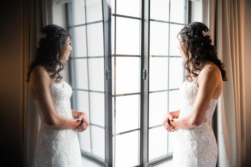 Bridal portrait reflected in a window