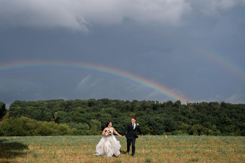 Couple beneath a rainbow