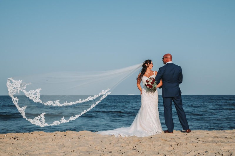 Wedding portrait at the coast with a flowing veil