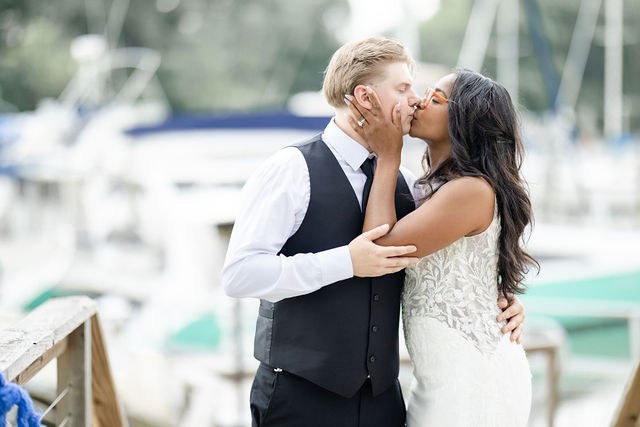 Newlyweds sharing a kiss outdoors
