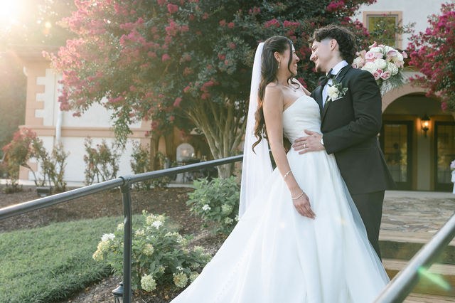 Bride and groom sharing a kiss in warm evening light