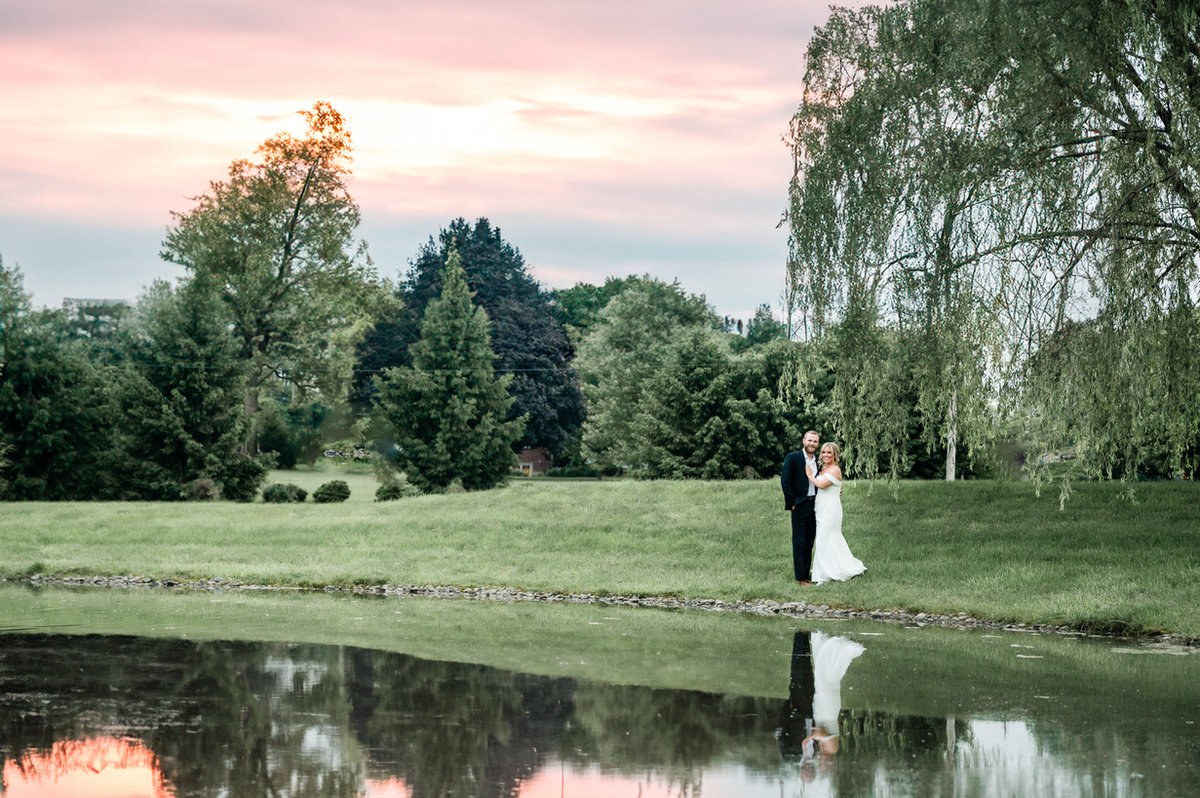 Couple reflected in a pond at sunset