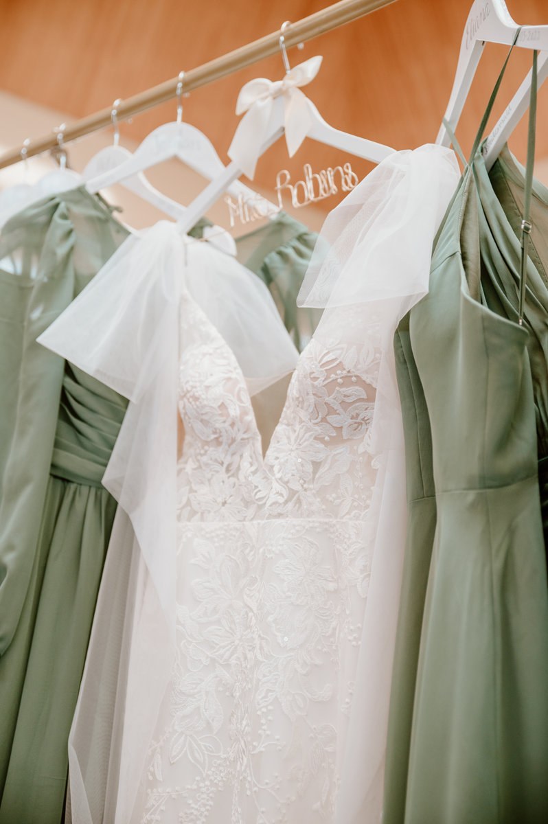Wedding dress and bridesmaid dresses hanging together