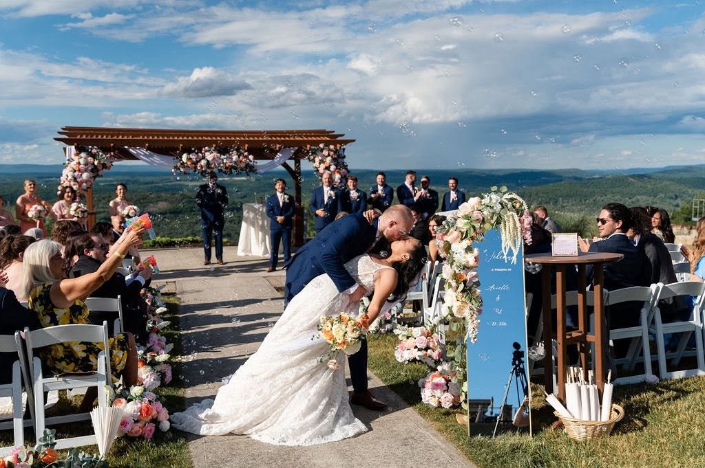 Wedding ceremony beneath a blue sky by the water