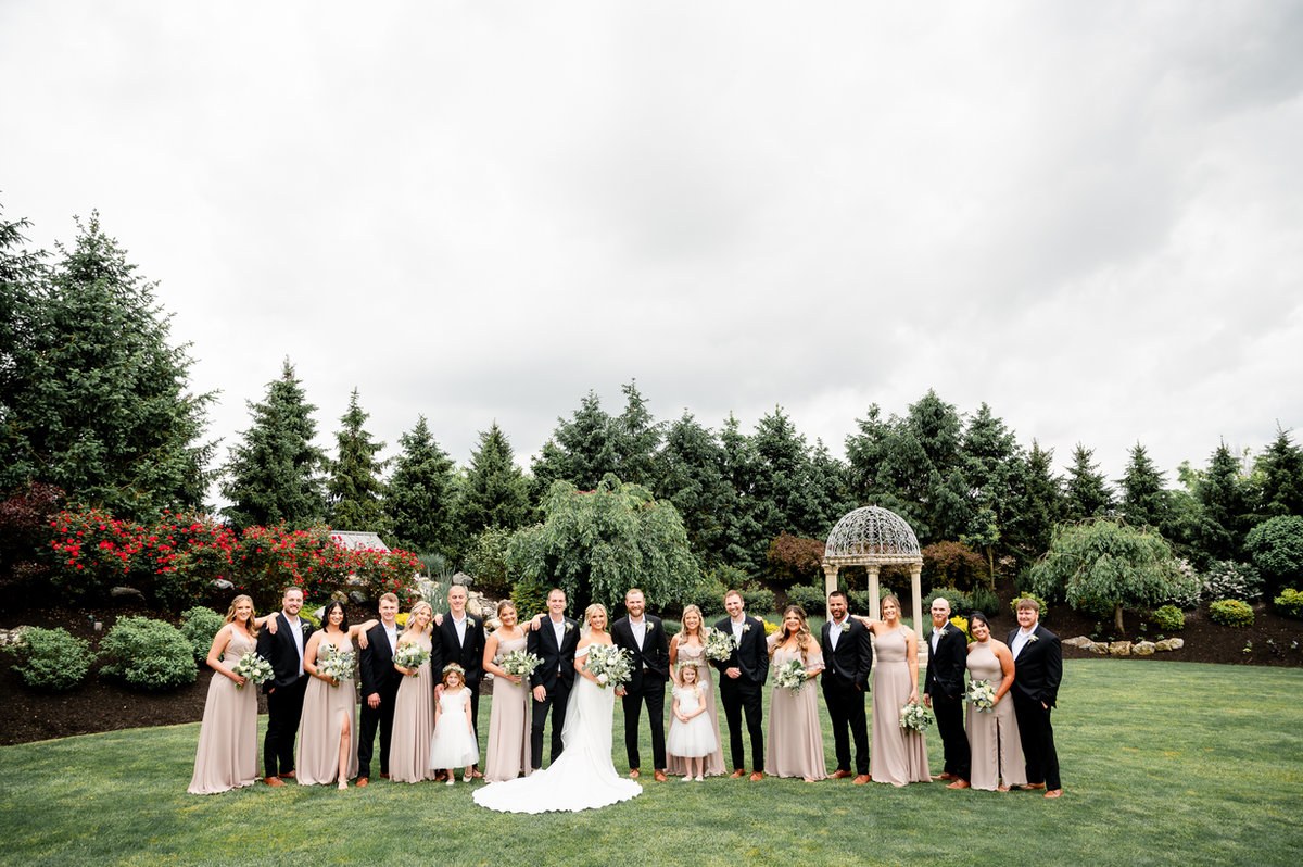Bride and groom with their wedding party in a garden