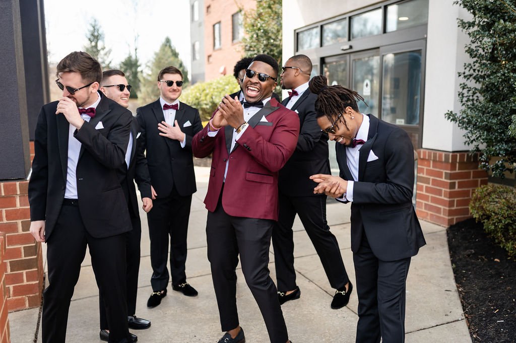 Groom laughing with his groomsmen